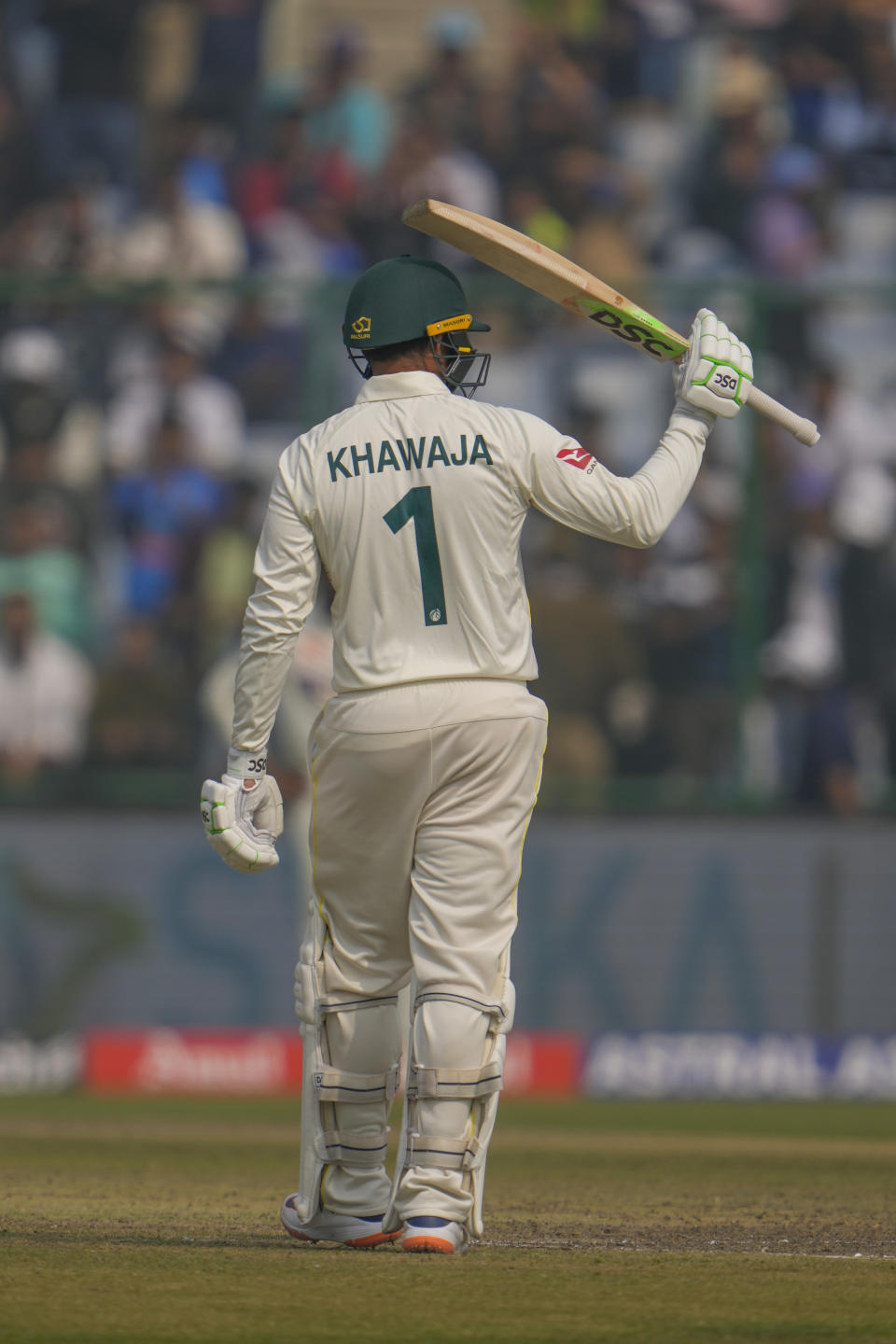 Australia's Usman Khawaja raises his bat to celebrate scoring a half century during the first day of the second cricket test match between India and Australia in New Delhi, India, Friday, Feb. 17, 2023. (AP Photo/Altaf Qadri)