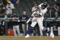 Seattle Mariners' Taylor Trammell hits an RBI-double to score Luis Torrens during the fourth inning of a baseball game against the Los Angeles Dodgers, Monday, April 19, 2021, in Seattle. (AP Photo/Ted S. Warren)