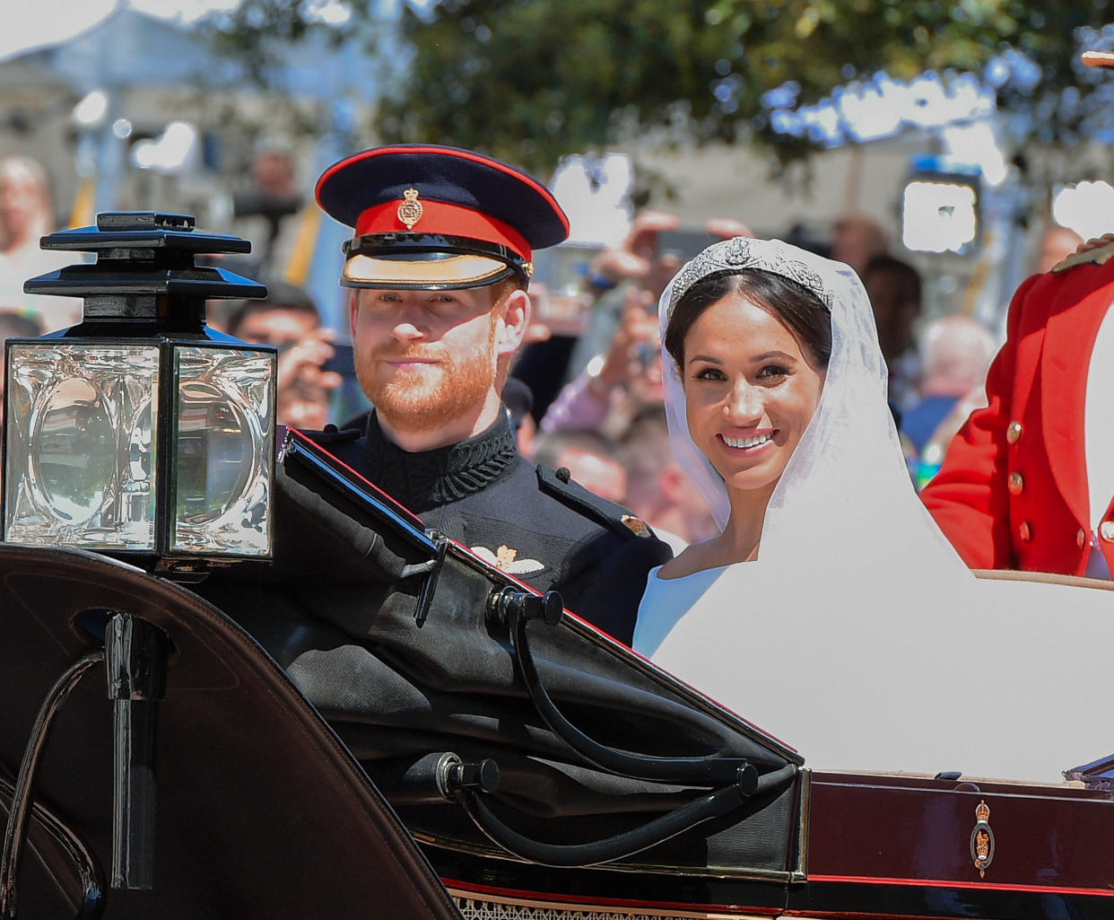 The Duke and Duchess of Sussex leave Windsor Castle in the Ascot Landau carriage during a procession after their nuptials. 