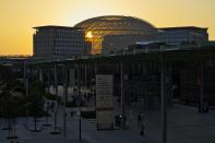 The sun sets behind the Al-Wasl Dome at Expo 2020 in Dubai, United Arab Emirates, Monday, Oct. 18, 2021. (AP Photo/Jon Gambrell)