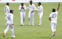 India's Rohit Sharma, second left, reacts as he takes a catch to dismiss Australia's Cameron Green during play on day four of the fourth cricket test between India and Australia at the Gabba, Brisbane, Australia, Monday, Jan. 18, 2021. (AP Photo/Tertius Pickard)