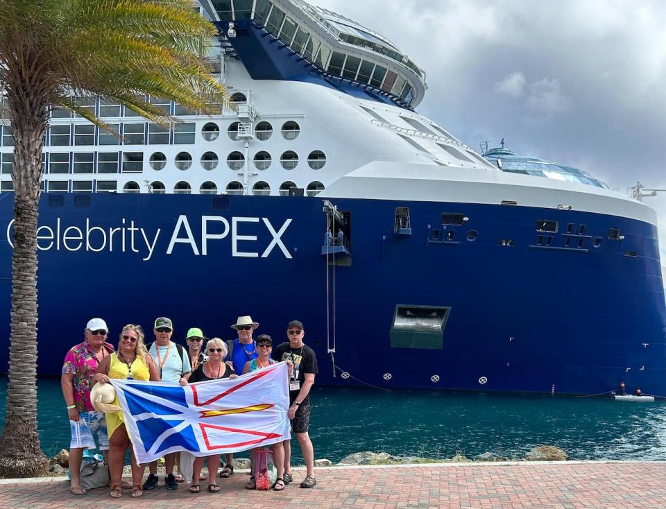 Pam Pardy, in yellow, poses with friends in front of the Celebrity Apex in early April.