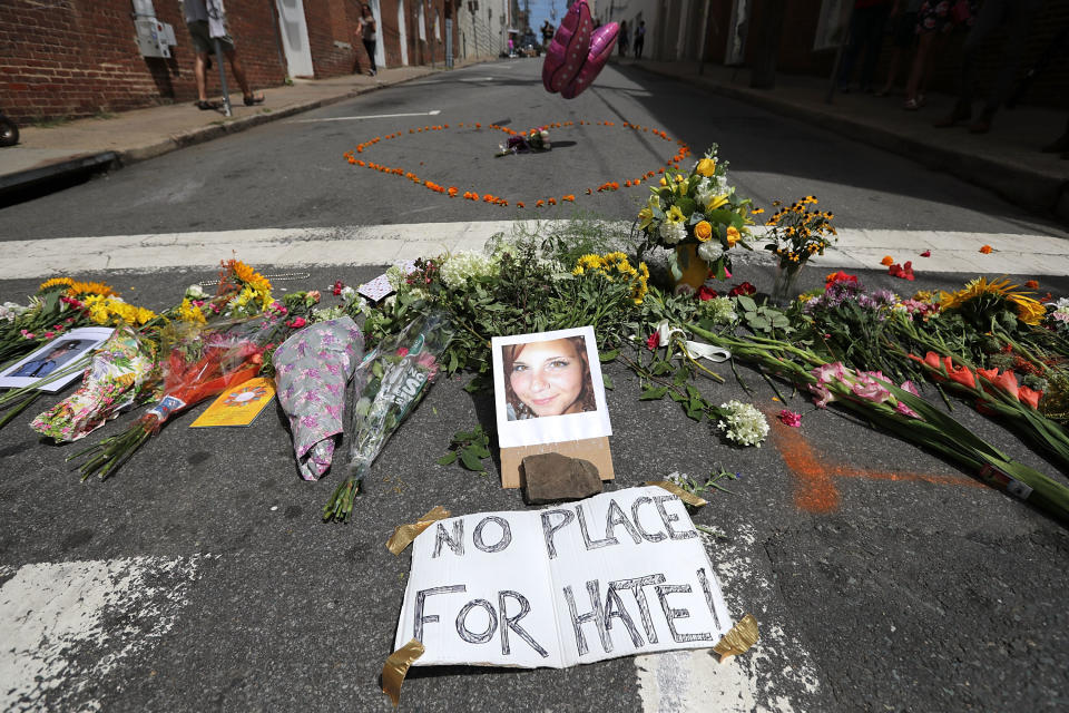 Flowers surround a photo of 32-year-old Heather Heyer, who was killed when a car plowed into a crowd of people protesting against the white supremacist Unite the Right rally. (Photo: Chip Somodevilla/Getty Images)