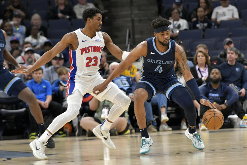 Memphis Grizzlies guard Jordan Goodwin (4) handles the ball against Detroit Pistons guard Jaden Ivey (23) in the first half of an NBA basketball game Friday, April 5, 2024, in Memphis, Tenn. (AP Photo/Brandon Dill)