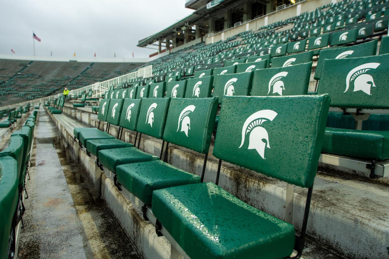 Empty seats at the Michigan State stadium emblazoned with the MSU logo