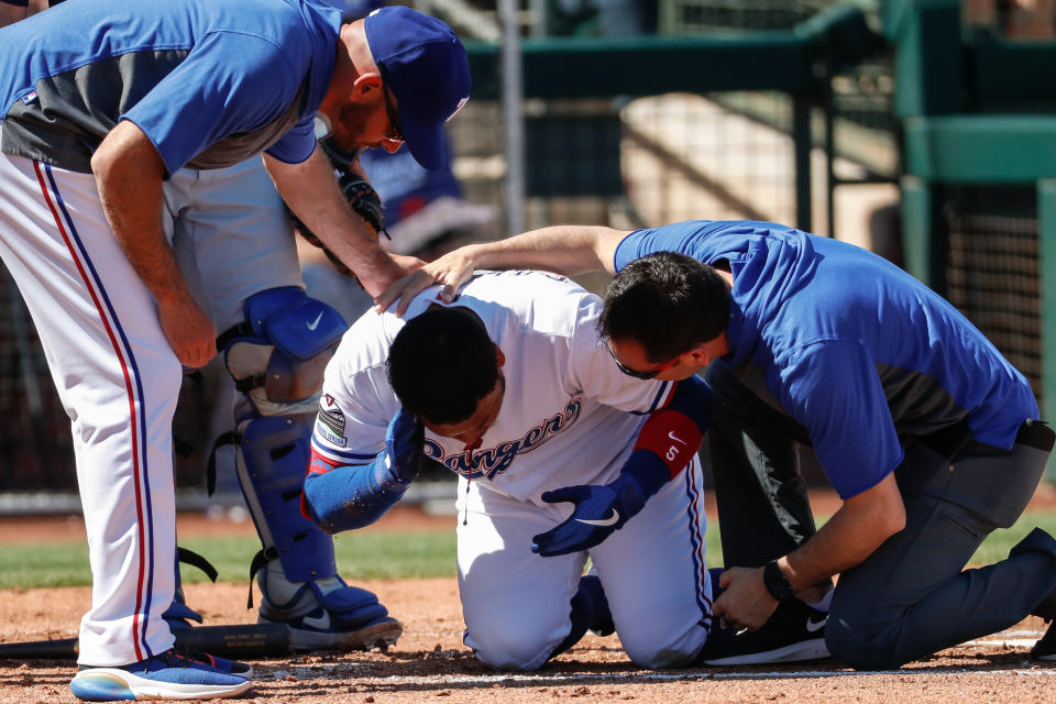 SURPRISE, AZ - MARCH 08: Texas Rangers left fielder Willie Calhoun (5) grabs his face after he's hit by a pitch during the spring training MLB baseball game between the Los Angeles Dodgers and the Texas Rangers on March 8, 2020 at Surprise Stadium in Surprise, Arizona. (Photo by Kevin Abele/Icon Sportswire via Getty Images)