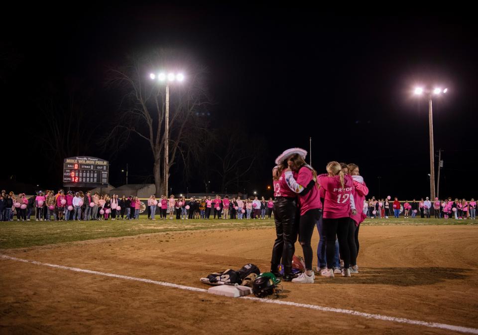 Close friends and family of Ashton Pryor gather at third base during during her candlelight celebration at Mike Wilson Field at Boonville High School in Boonville, Ind., Sunday evening, Feb. 19, 2023. Ashton was killed Friday morning in a single car accident while on her way to school.