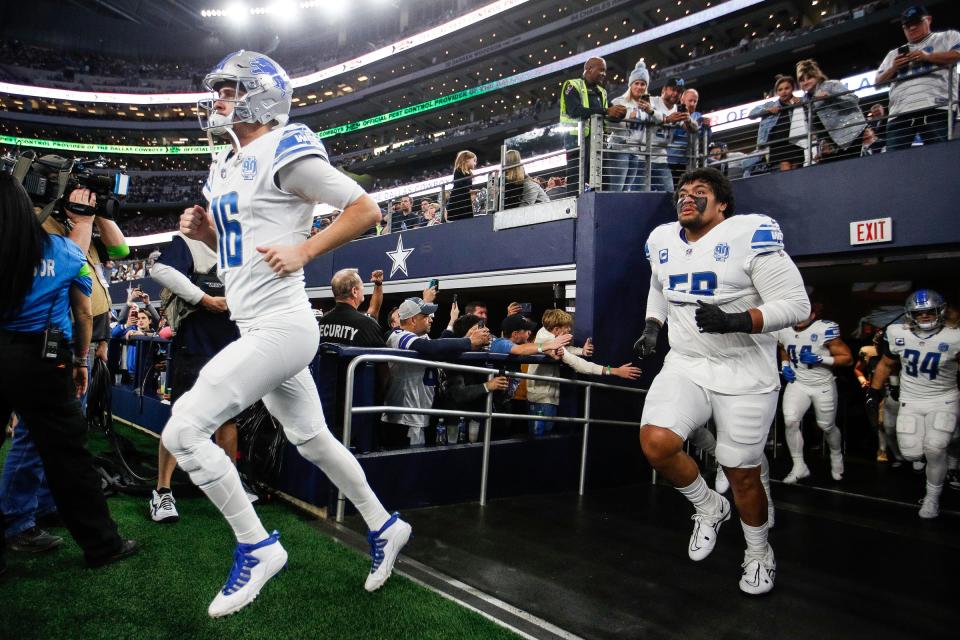Detroit Lions offensive tackle Penei Sewell follows quarterback Jared Goff as the team takes the field against the Dallas Cowboys at AT&T Stadium in Arlington, Texas on Saturday, Dec. 30, 2023.