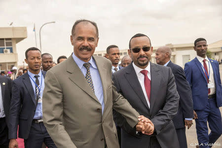 Eritrean President Isaias Afwerki and Ethiopia's Prime Minister Abiy Ahmed and walk together at Asmara International Airport, Eritrea July 9, 2018 in this photo obtained from social media on July 10, 2018. GHIDEON MUSA ARON VISAFRIC/via REUTERS