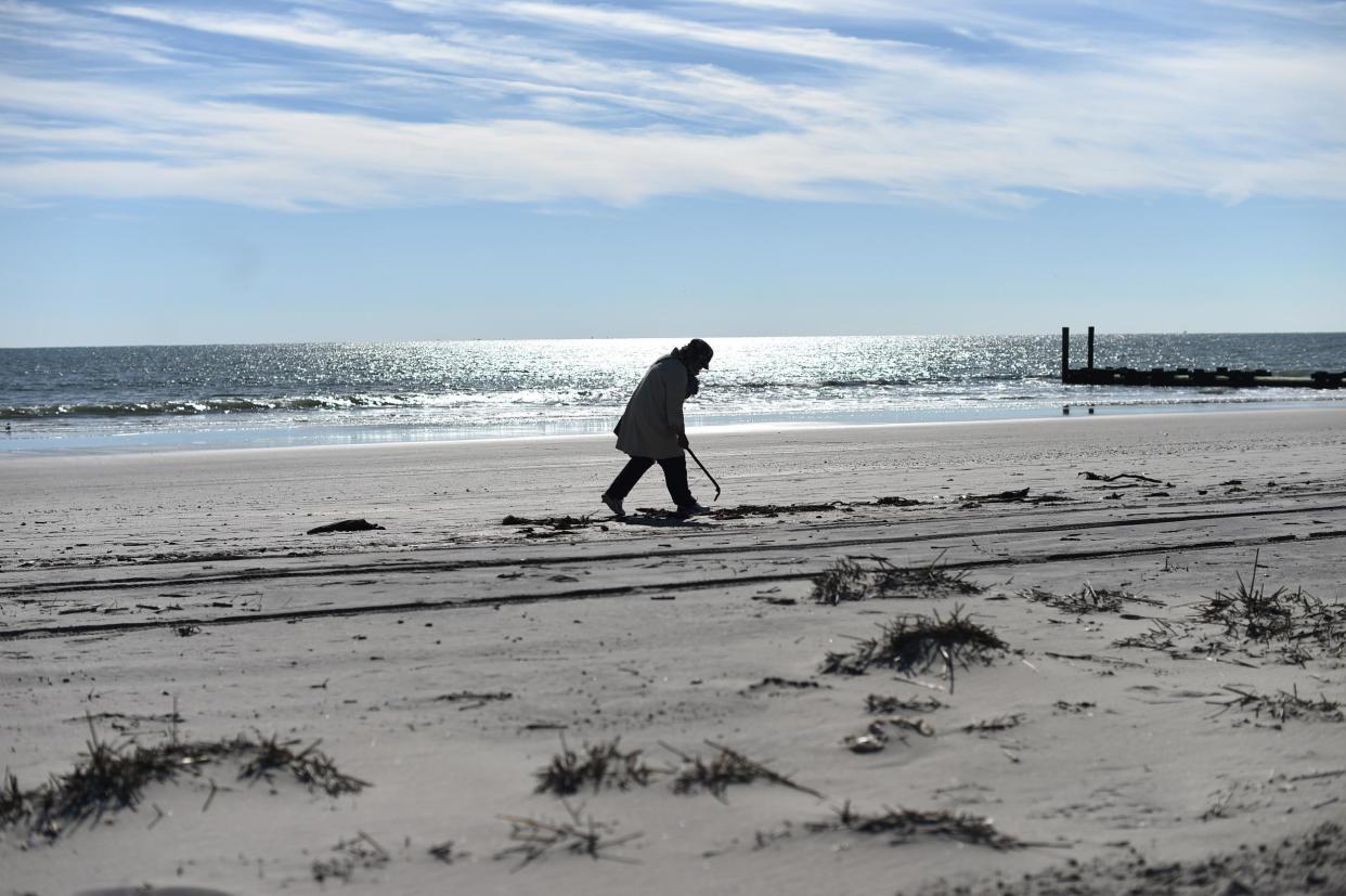 A woman walks along the beach in Ocean City, New Jersey: JEWEL SAMAD/AFP/Getty Images