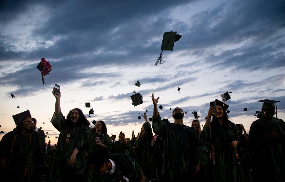 Members of the class of 2024 from Palmetto Ridge High School toss their caps after commencement at Palmetto Ridge in Naples on Thursday, May 23, 2024. The 518 seniors at the high school were among 3,400-plus Collier County School District students graduating this year. This is the 20th anniversary of the school.