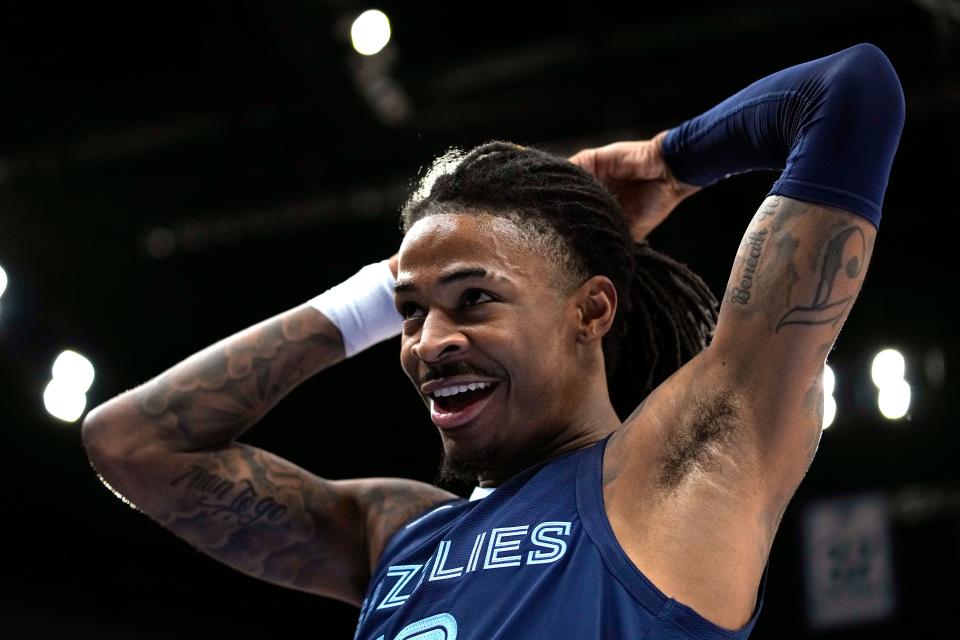 Memphis Grizzlies guard Ja Morant (12) reacts during the first half of an NBA basketball game against the Minnesota Timberwolves, Friday, Jan. 27, 2023, in Minneapolis. (AP Photo/Abbie Parr)