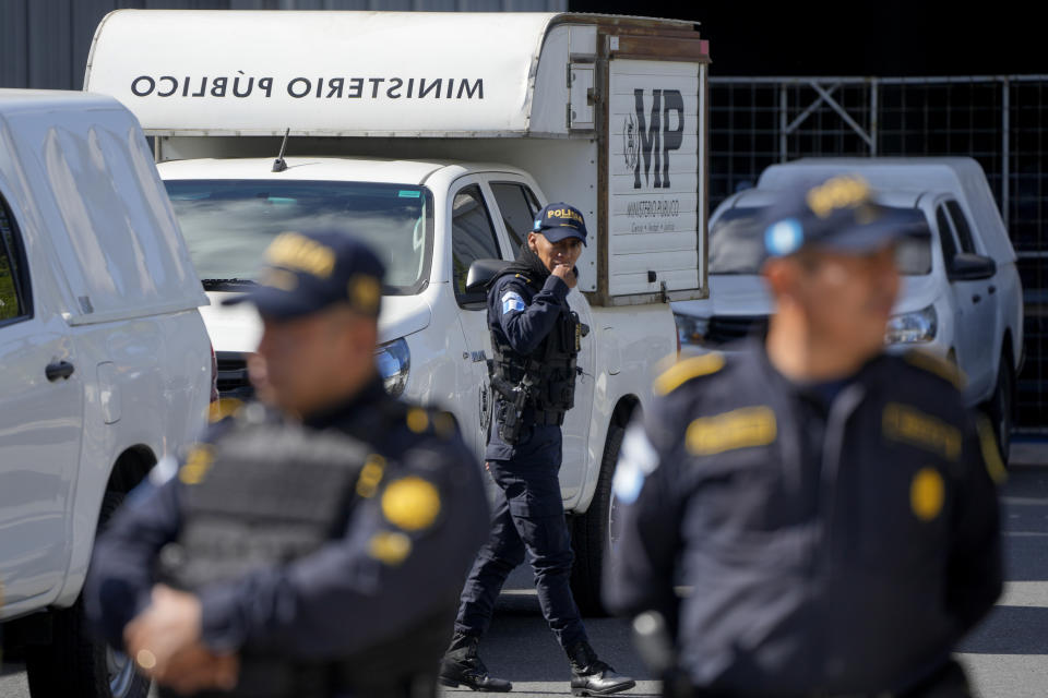 Policemen stand guard as agents from the Attorney General's office raid a temporary facility of the Supreme Electoral Tribunal, in Guatemala City, Tuesday, Sept. 12, 2023. (AP Photo/Moises Castillo)