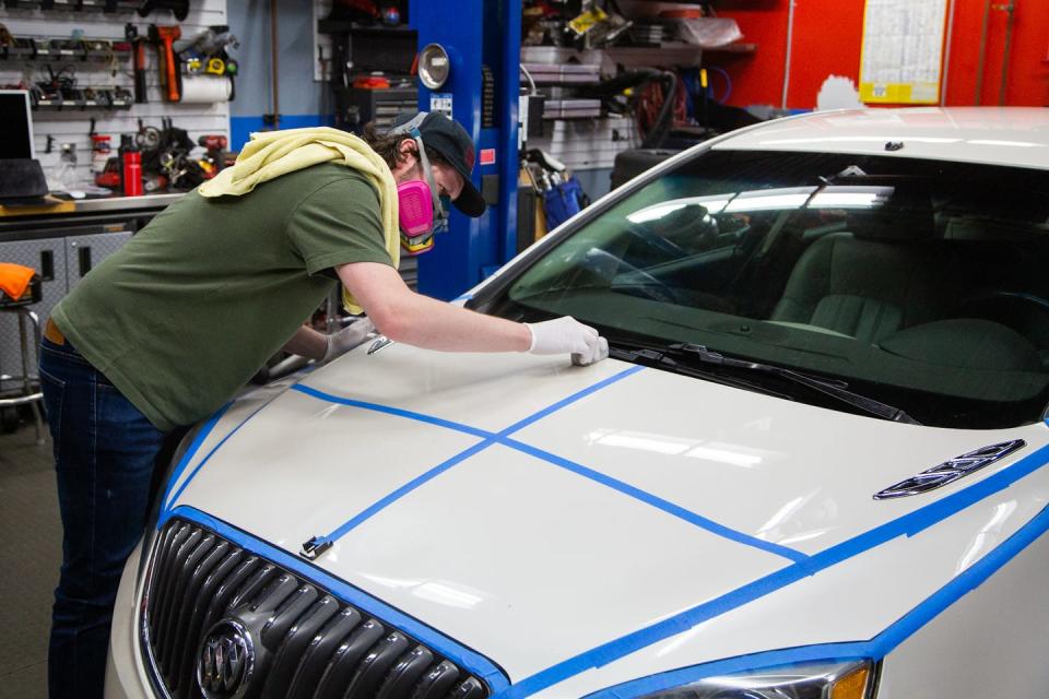 car and driver associate testing editor gannon burgett applying a ceramic coating to his buick verano