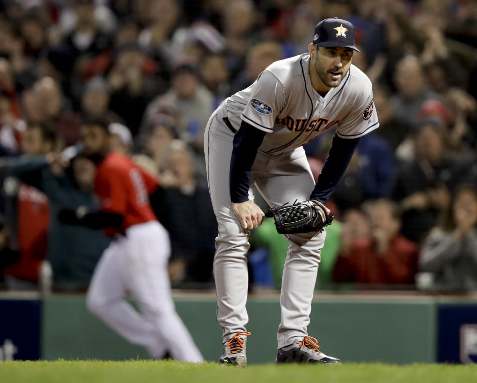 Houston Astros starting pitcher Justin Verlander reacts after Boston Red Sox's Jackie Bradley Jr. scored on a wild pitch during the fifth inning in Game 1 of a baseball American League Championship Series on Saturday, Oct. 13, 2018, in Boston. (AP Photo/Charles Krupa)