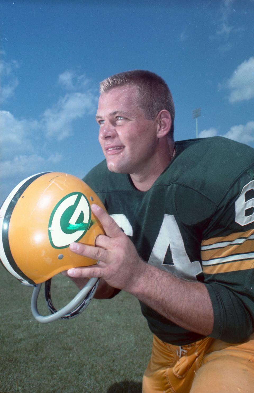 Jerry Kramer, a Hall of Fame offensive lineman for the Green Bay Packers, holds his helmet in 1961.