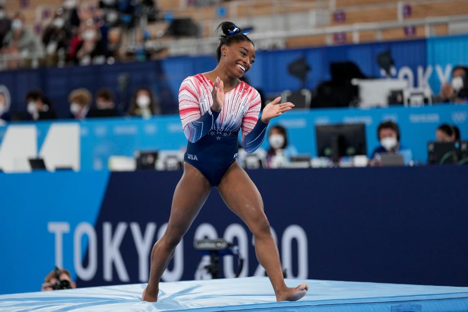 Simone Biles, of the United States, reacts after finishing on the balance beam.