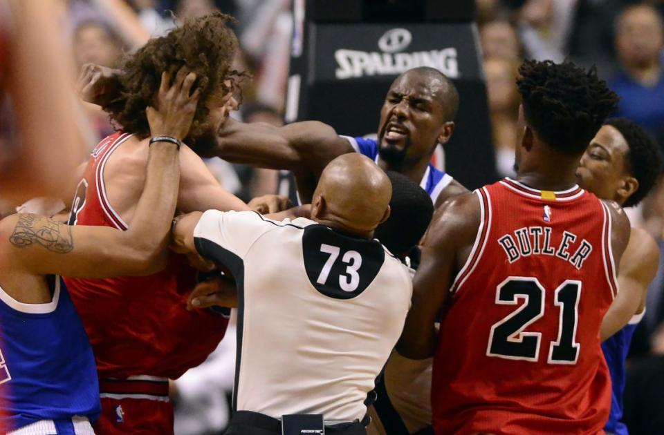 <p>Toronto Raptors forward Serge Ibaka (9) lands a strike on Chicago Bulls center Robin Lopez (8) during a scuffle during second half of an NBA basketball game in Toronto, Tuesday, March 21, 2017. (Frank Gunn/The Canadian Press via AP) </p>