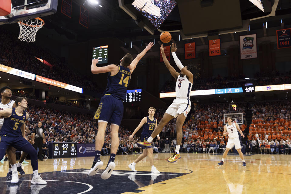 Virginia's Armaan Franklin (4) shoots the ball while defended by Notre Dame's Nate Laszewski (14) during the second half of an NCAA college basketball game in Charlottesville, Va., Saturday, Feb. 18, 2023. (AP Photo/Mike Kropf)