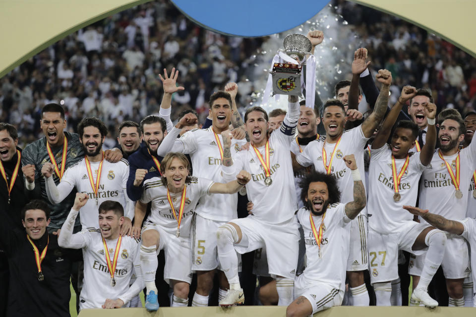 Real Madrid's Sergio Ramos holds up the trophy, at the end of the Spanish Super Cup Final soccer match between Real Madrid and Atletico Madrid at King Abdullah stadium in Jiddah, Saudi Arabia, Monday, Jan. 13, 2020. (AP Photo/Hassan Ammar)