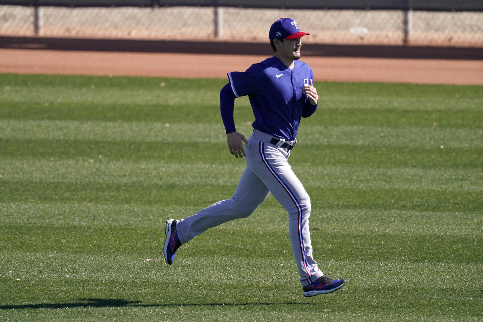 Texas Rangers pitcher Kohei Arihara, from Japan, runs during spring training baseball practice Wednesday, Feb. 24, 2021, in Surprise, Ariz. (AP Photo/Charlie Riedel)