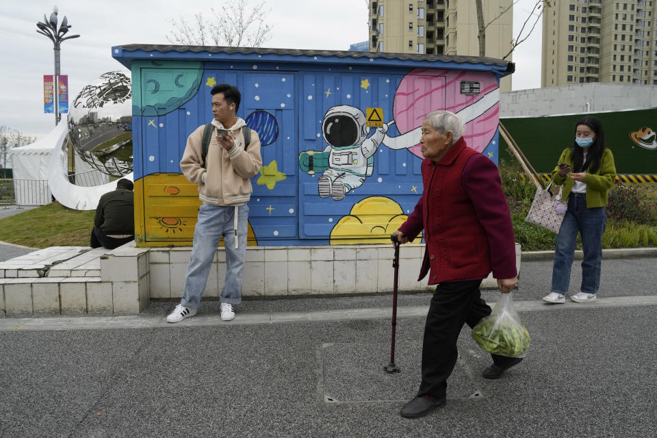 People pass artworks outside the World Science Fiction Convention in Chengdu, Sichuan province on Friday, Oct. 20, 2023. The series that began with "The Three-Body Problem," written by former engineer Liu Cixin, helped Chinese science fiction break through internationally, winning awards and making it onto the reading lists of the likes of former U.S. President Barack Obama and Mark Zuckerberg. (AP Photo/Ng Han Guan)