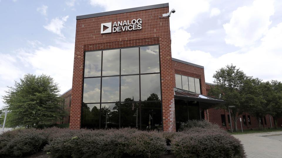 Clouds are reflected in the headquarters of Analog Devices, Inc., Monday, July 13, 2020, in Norwood, Mass. Computer chip maker Analog Devices is buying Maxim Integrated in an all-stock deal that will create a company worth about $68 billion, and strengthens its position in the analog semiconductor sector. (AP Photo/Steven Senne)