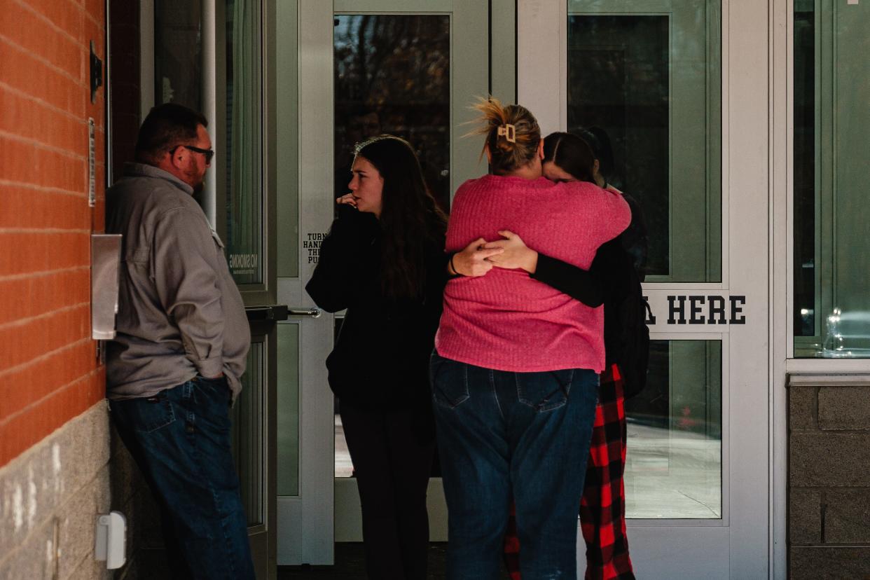 Parents and students embrace Tuesday outside a vestibule at Tuscarawas Valley Middle/High School in Zoarville.
