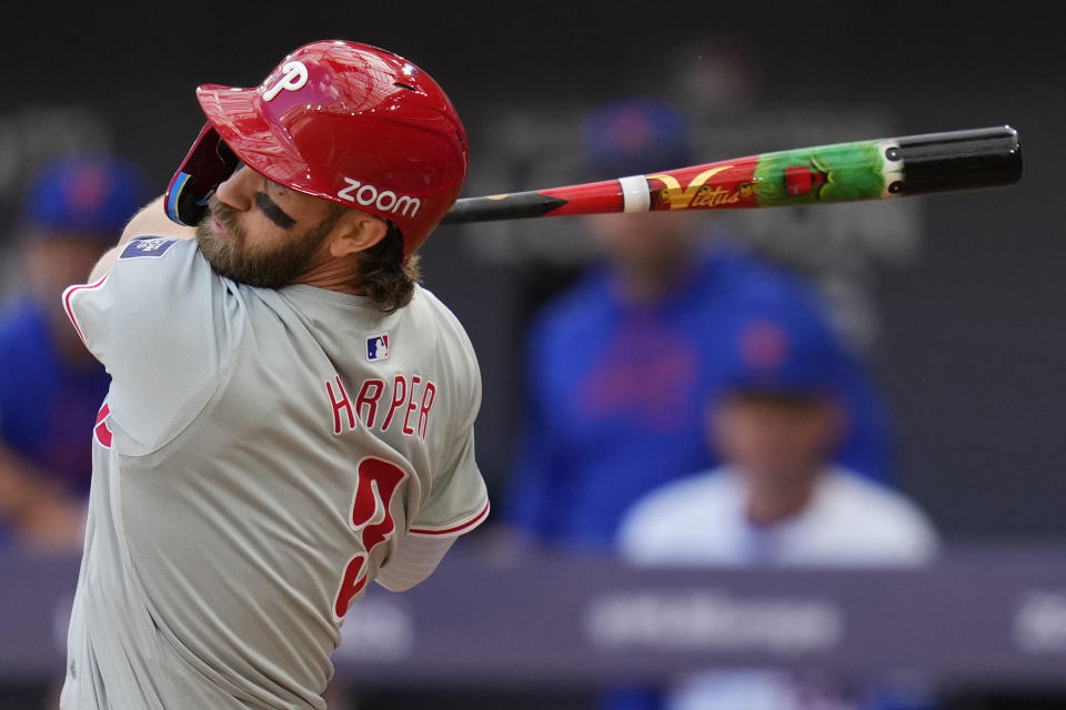 Philadelphia Phillies' Bryce Harper (3) swings at a pitch with a decorated bat during the first inning of a London Series baseball game against the New York Mets in London, Saturday, June 8, 2024. (AP Photo/Kirsty Wigglesworth)