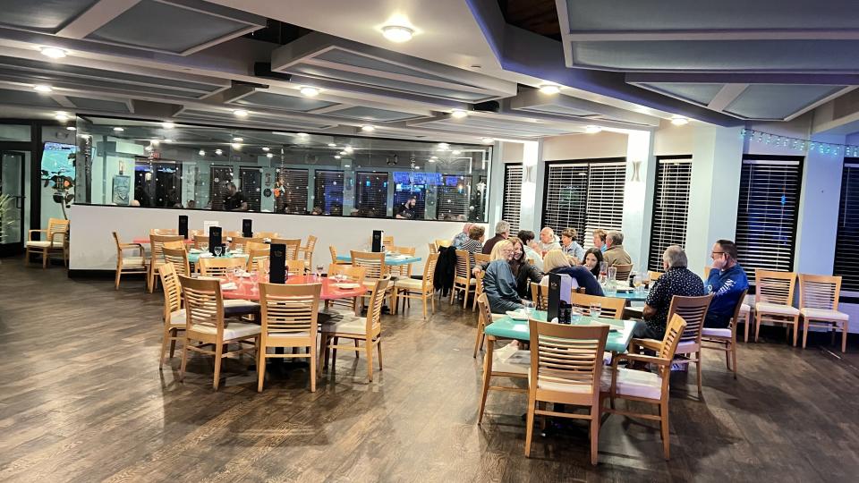 At Island Beach Bar & Restaurant in Ocean Village in Fort Pierce, the large indoor dining area is decorated in turquoise blue and light wood.