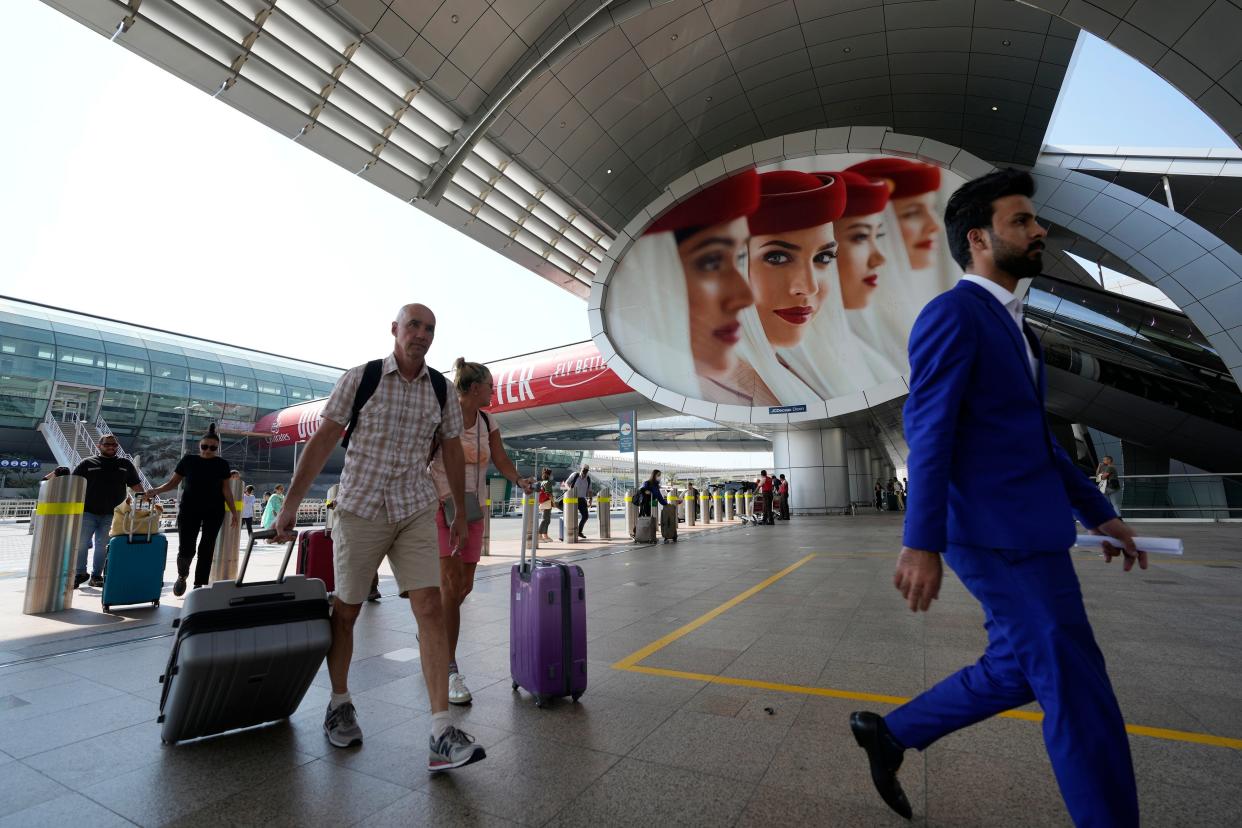 Passengers arrive at Dubai International Airport on Oct. 25, 2022.