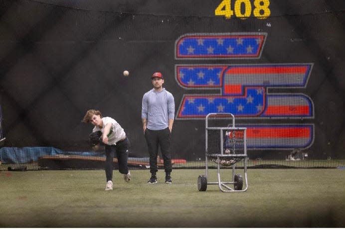 Jeff Singer training one of his pitchers