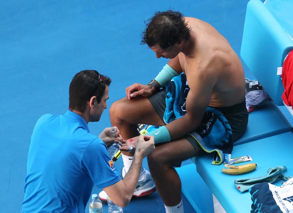 Rafael Nadal of Spain receives medical treatment to a blister on his hand during his quarterfinal against Grigor Dimitrov of Bulgaria at the Australian Open tennis championship in Melbourne, Australia, Wednesday, Jan. 22, 2014.(AP Photo/Eugene Hoshiko)