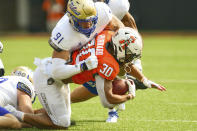 Tulsa defensive end Bryce Alonso (91) tackles Oklahoma State running back Chuba Hubbard (30) during the first half of an NCAA college football game, Saturday, Sept. 19, 2020, in Stillwater, Okla. (AP Photo/Brody Schmidt)