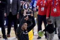 Milwaukee Bucks forward Giannis Antetokounmpo hols up the trophy after basketball's NBA All-Star Game in Atlanta, Sunday, March 7, 2021. (AP Photo/Brynn Anderson)