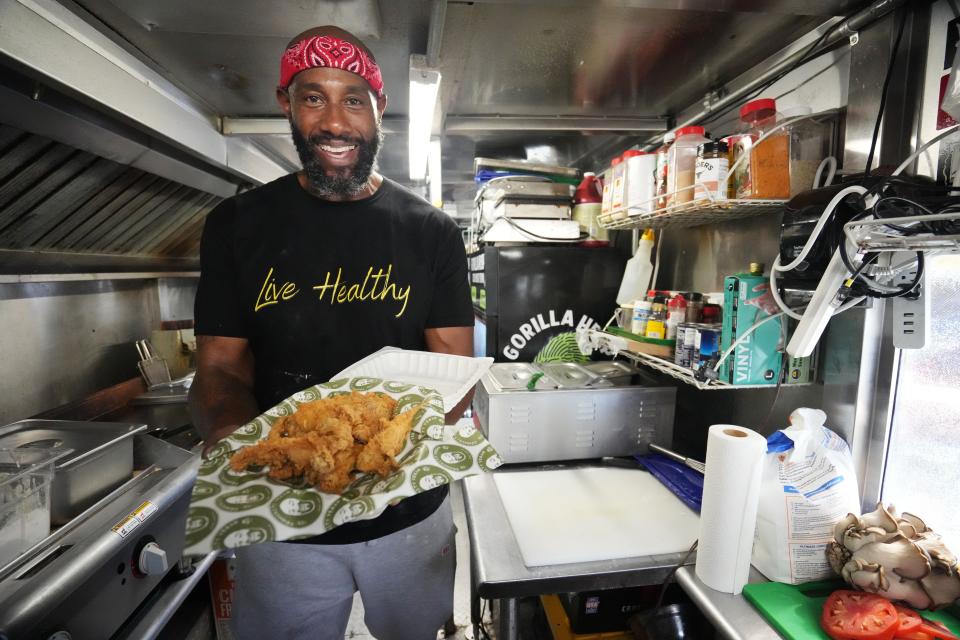 Marlon Rison, Community Vegan food truck co-owner and vegan cook, makes lemon pepper wings inside his food truck.