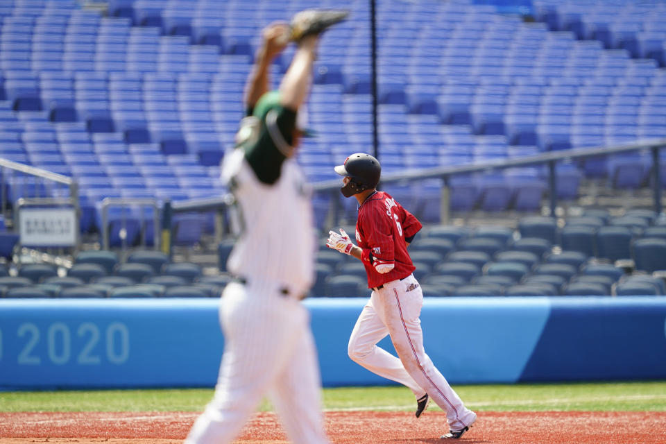 Japan's Hayato Sakamoto, right, rounds the bases past Mexico's Manuel Banuelos after hitting a home run during a baseball game at Yokohama Baseball Stadium during the 2020 Summer Olympics, Saturday, July 31, 2021, in Yokohama, Japan. (AP Photo/Matt Slocum)