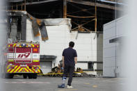 A man wearing a bandage on his right hand and a cast on left leg looks at the site of a burnt battery manufacturing factory in Hwaseong, South Korea, Tuesday, June 25, 2024. (AP Photo/Lee Jin-man)