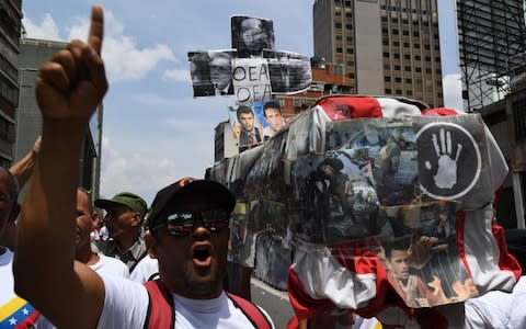 Supporters of Venezuelan President Nicolas Maduro demonstrate against the US President Donald Trump - Credit: YURI CORTEZ/&nbsp;AFP