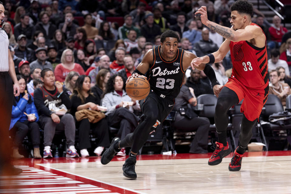 Detroit Pistons guard Jaden Ivey (23) drives to the hoop against Portland Trail Blazers forward Toumani Camara, right, during the second half of an NBA basketball game Thursday, Feb. 8, 2024, in Portland, Ore. (AP Photo/Howard Lao)