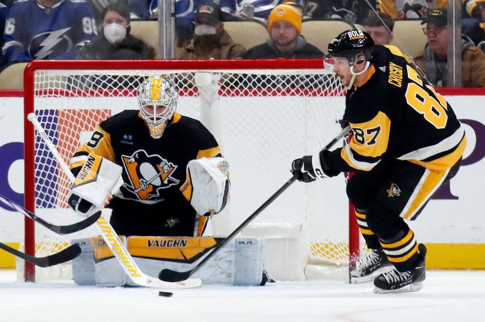 Penguins center Sidney Crosby clears the puck after a save by goaltender Alex Nedeljkovic during the third period of the win over the Lightning on Saturday, April 6, 2024, in Pittsburgh.