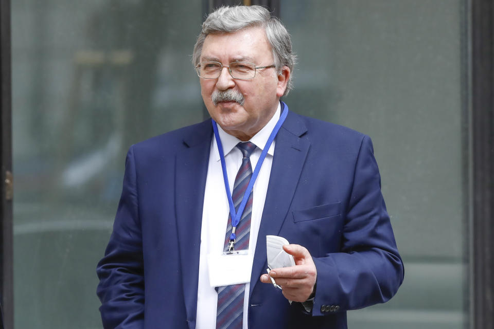 FILE - In this April 20, 2021 file photo Russia's Governor to the International Atomic Energy Agency, IAEA, Mikhail Ulyanov smokes a cigarette in front of the 'Grand Hotel Wien' where closed-door nuclear talks with Iran take place in Vienna, Austria. (AP Photo/Lisa Leutner, file)