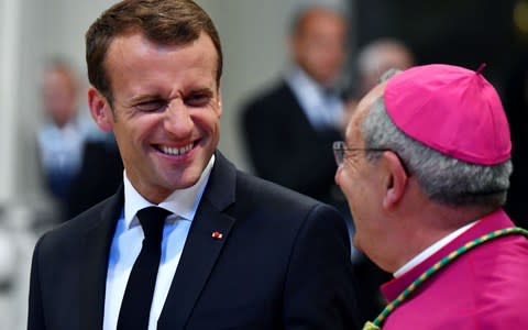 French President Emmanuel Macron (L) smiles to vicar of Rome bishop Angelo De Donatis (R) in the popes cathedral, Archbasilica of St. John Lateran in Rome on June 26, 2018 - Credit:  ALBERTO PIZZOLI/AFP