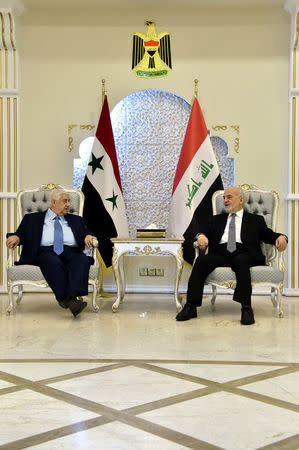 Iraq's Foreign Minister Ibrahim al-Jaafari (R) meets with his Syrian counterpart Walid al-Muallem at Baghdad airport August 25, 2016. Iraqi Foreign Minister Office/Handout via REUTERS