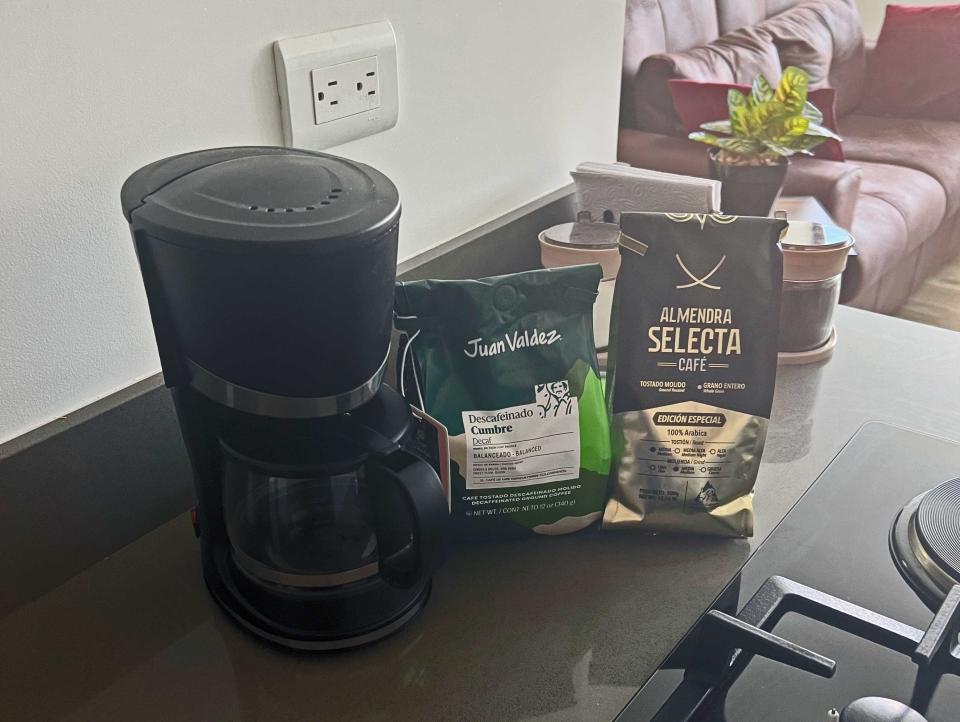 A coffee maker with coffee on a counter.