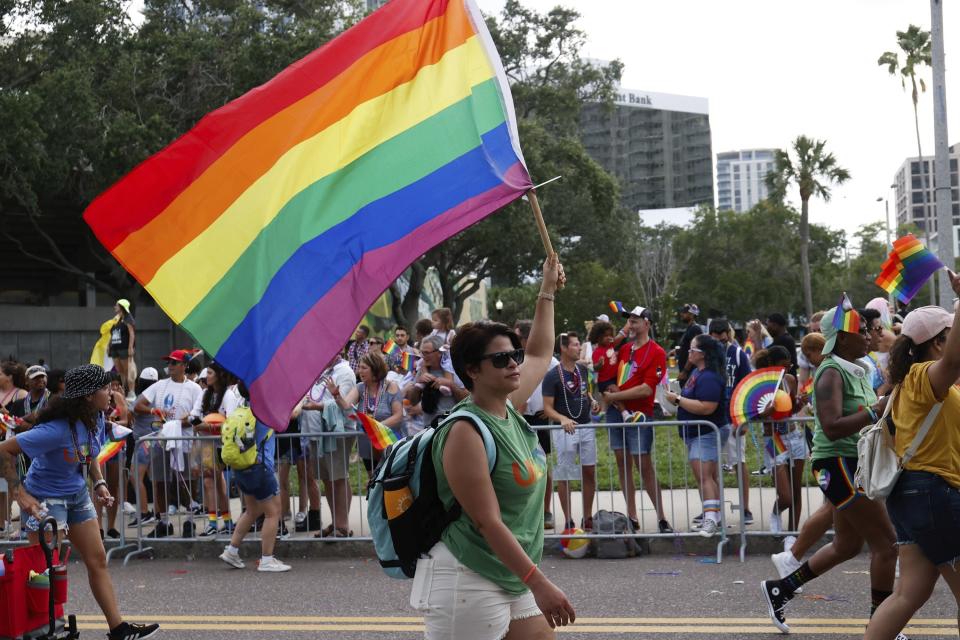 A Pride flag is waved by a parade participant during the St. Pete Pride Parade along Bayshore Drive on Saturday, June 24, 2023, in St. Petersburg, Fla. (Jefferee Woo/Tampa Bay Times via AP)