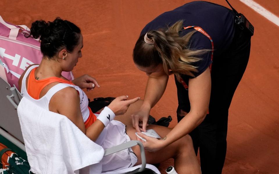 Martina Trevisan receives medical attention during her semi-final against Coco Gauff - Christophe Ena/AP