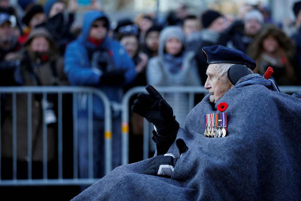 <p>A veteran waves to the crowd as he arrives for Remembrance Day ceremonies at the National War Memorial in Ottawa, Ontario, Canada, Nov. 11, 2017. (Photo: Chris Wattie/Reuters) </p>