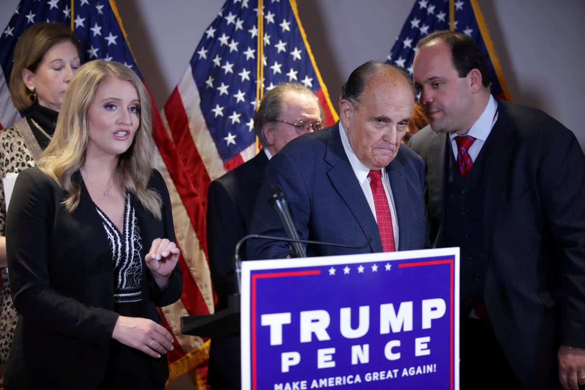 Trump campaign senior legal adviser Jenna Ellis speaks as campaign adviser Boris Epshteyn speaks to former New York City Mayor Rudy Giuliani, then-personal attorney to Trump, and attorney Sidney Powell, left at back, looks on  (REUTERS)