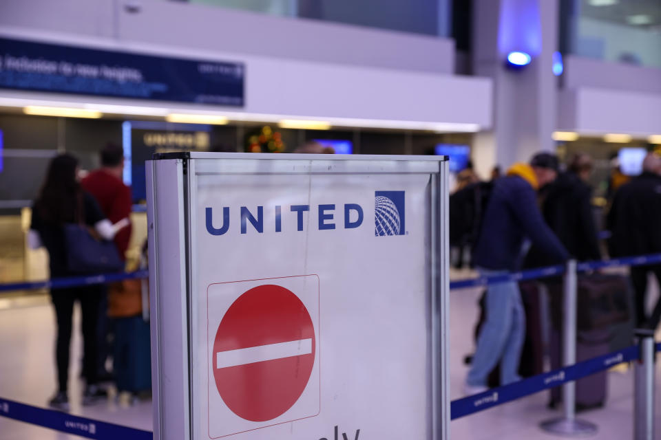 People are seen by the United Airlines counter at the Newark International Airport in New Jersey, United States on December 27, 2021, amid rise in number of the fast-spreading Omicron coronavirus variant. (Photo by Tayfun Coskun/Anadolu Agency via Getty Images)